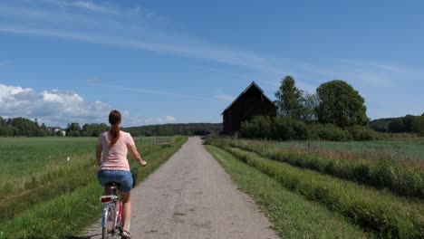 Frau-Fährt-Fahrrad-Auf-Der-Landstraße