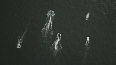 aerial view of boats and jet skis on the water