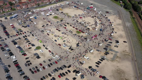 Floating-high-aerial-birdseye-drone-shot-towards-a-busy-market-and-car-boot-sale-in-Hull-England-UK