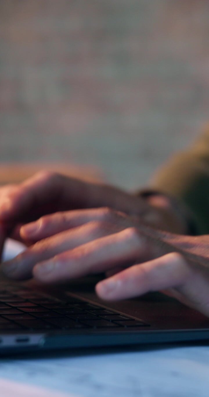 Close-up of Person Typing on Laptop Keyboard