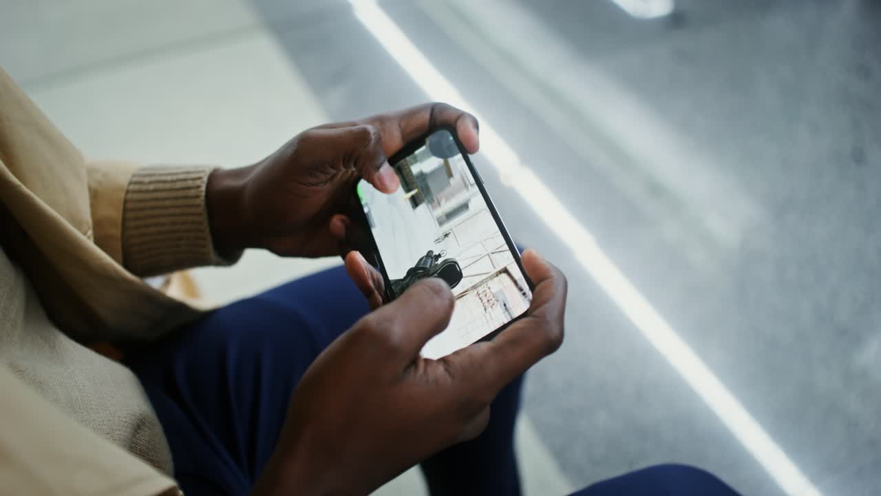Person playing a video game on a smartphone