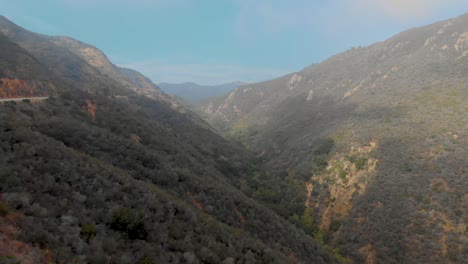 Slow-push-in-aerial-shot-of-mountain-canyons-near-Malibu,-Ca