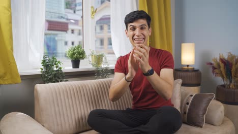 Man-giving-congratulatory-message-to-camera-applauding.