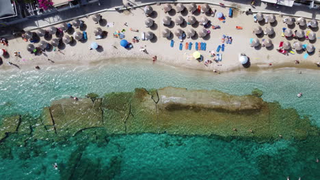 the beach at agia pelagia in crete sports an array of umbrellas