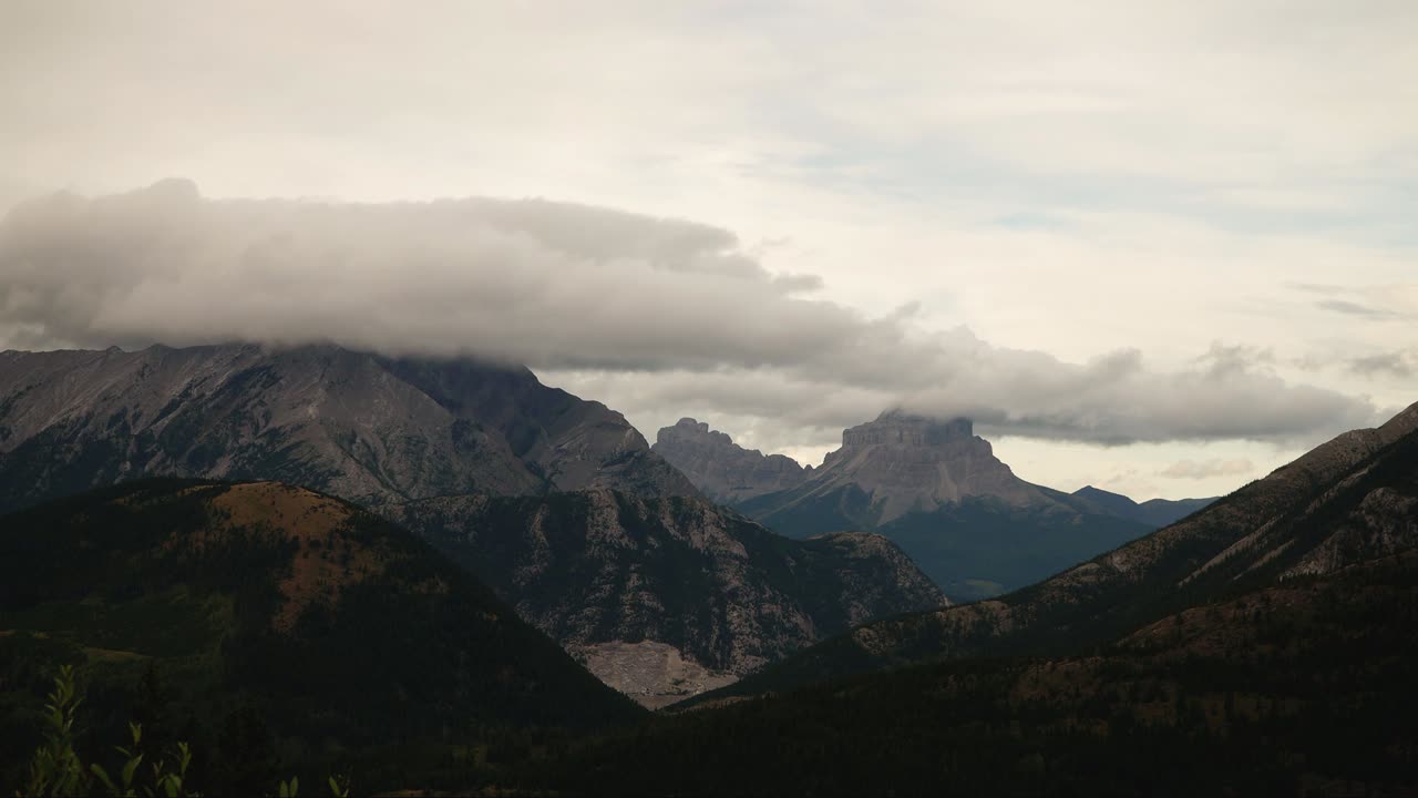 Clouds rolling across the peak of Crowsnest range, rocky mountains in Alberta Canada