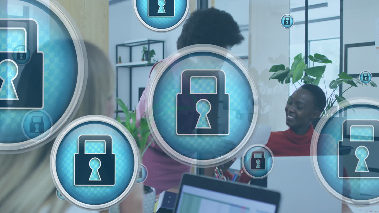 Animation of padlock in circles over diverse female coworkers discussing reports in office