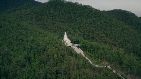 white buddha statue on pai hillside