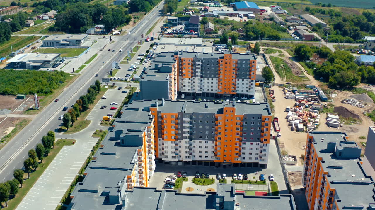 New residential complex from above. Multi-storey buildings for city residents in the new area with parking places. Aerial view.