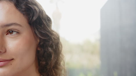 smiling woman with curly hair enjoying relaxation at home, close-up shot, copy space