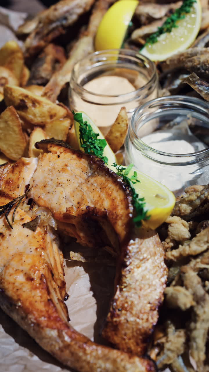 Close up of a Fritto Misto dish with salmon and potatoes at a restaurant. Vertical