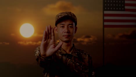 soldier presenting stop gesture at sunset