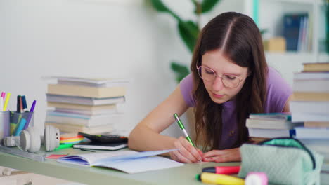 a young hard-working student does her homework and studies for school