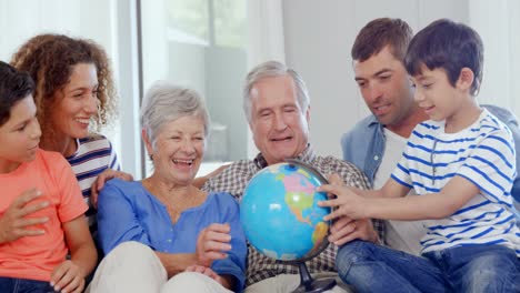 happy family looking at globe