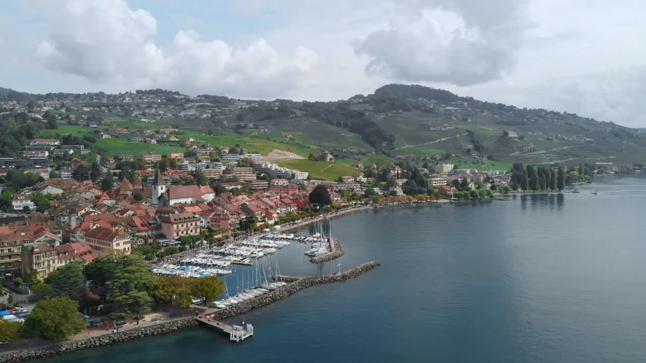 drone footage of swiss near Leman Lake, showing grape fields, boats, harbor, small towns