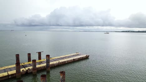 Drone-shot-revealing-poles-in-the-ocean