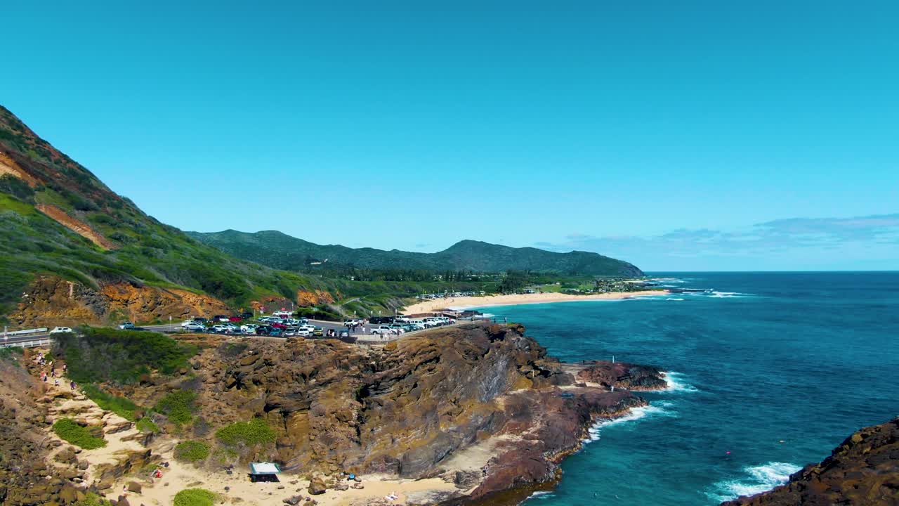 Descending a steep cliff towards the cove while revealing the stunning Ohau coastline