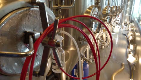 slow rise up row of steel brewing tanks in brewery, suncheon, south korea