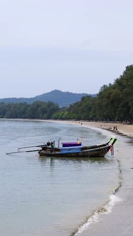 serene view of boat anchored at ao nang beach, krabi