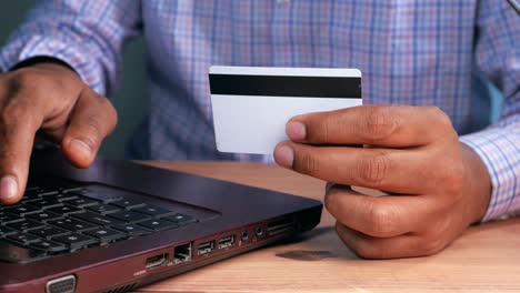 person using laptop and credit card for online shopping