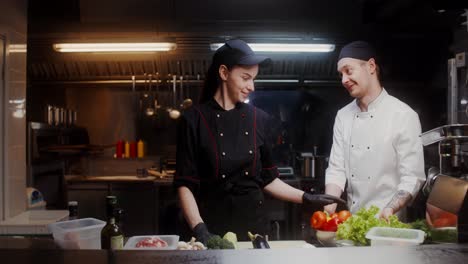 two chefs preparing vegetables in a restaurant kitchen