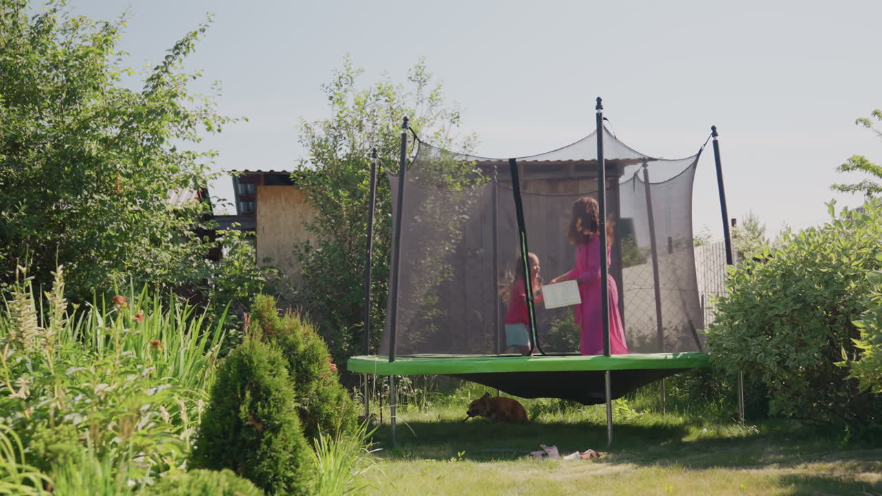 Laughter Fills Sunny Backyard, Energetic And Happy Children Jumping In Warm Outdoor Setting, Cheerful Mother And Child Share Moments Of Joy While Bouncing On Trampoline In Summer Yard