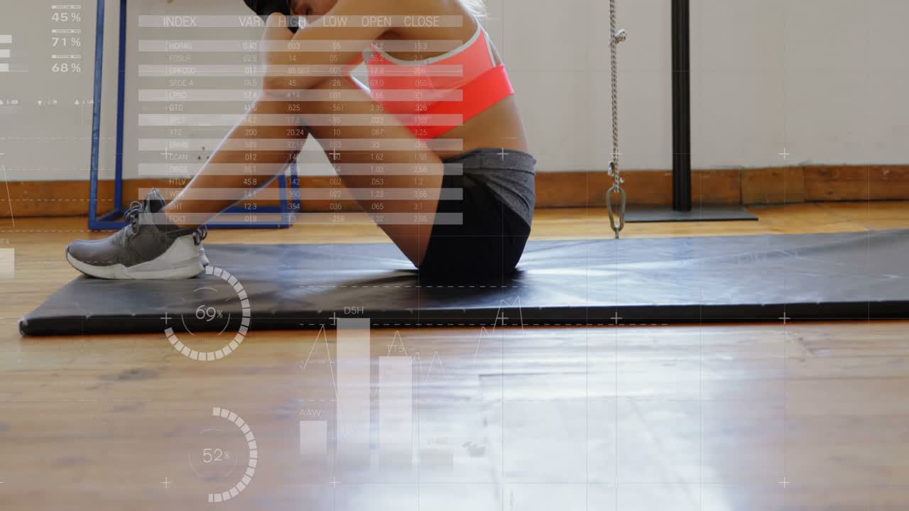 Female exerciser catching breath after sparring, resting on mat while HUD charts showing fatigue