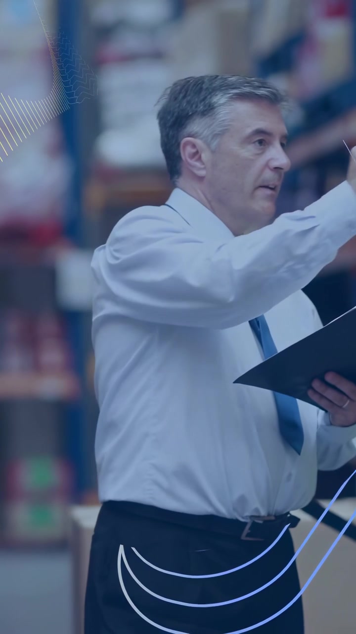 Vertical video: Warehouse mgr pointing, checking clipboard and noting racks while wave overlaying