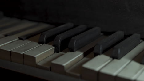 vintage piano neglected collecting dust close up keys