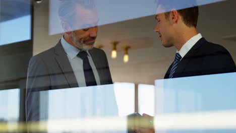 Two-men-watching-a-tablet-