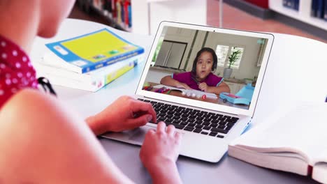 Caucasian-girl-using-laptop-while-having-a-video-call-with-african-american-boy-at-home