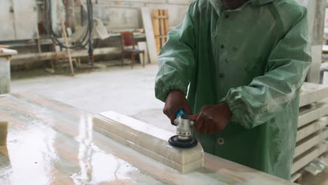 man polishing marble