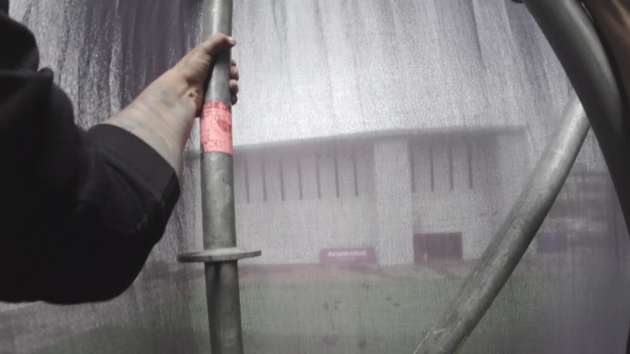 POV Shot of Worker's Hands Assembling Metal Scaffolding