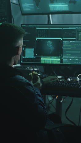 hacker eating lunch in a dark cyber security room