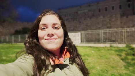 young woman taking selfies in jerusalem old city at night