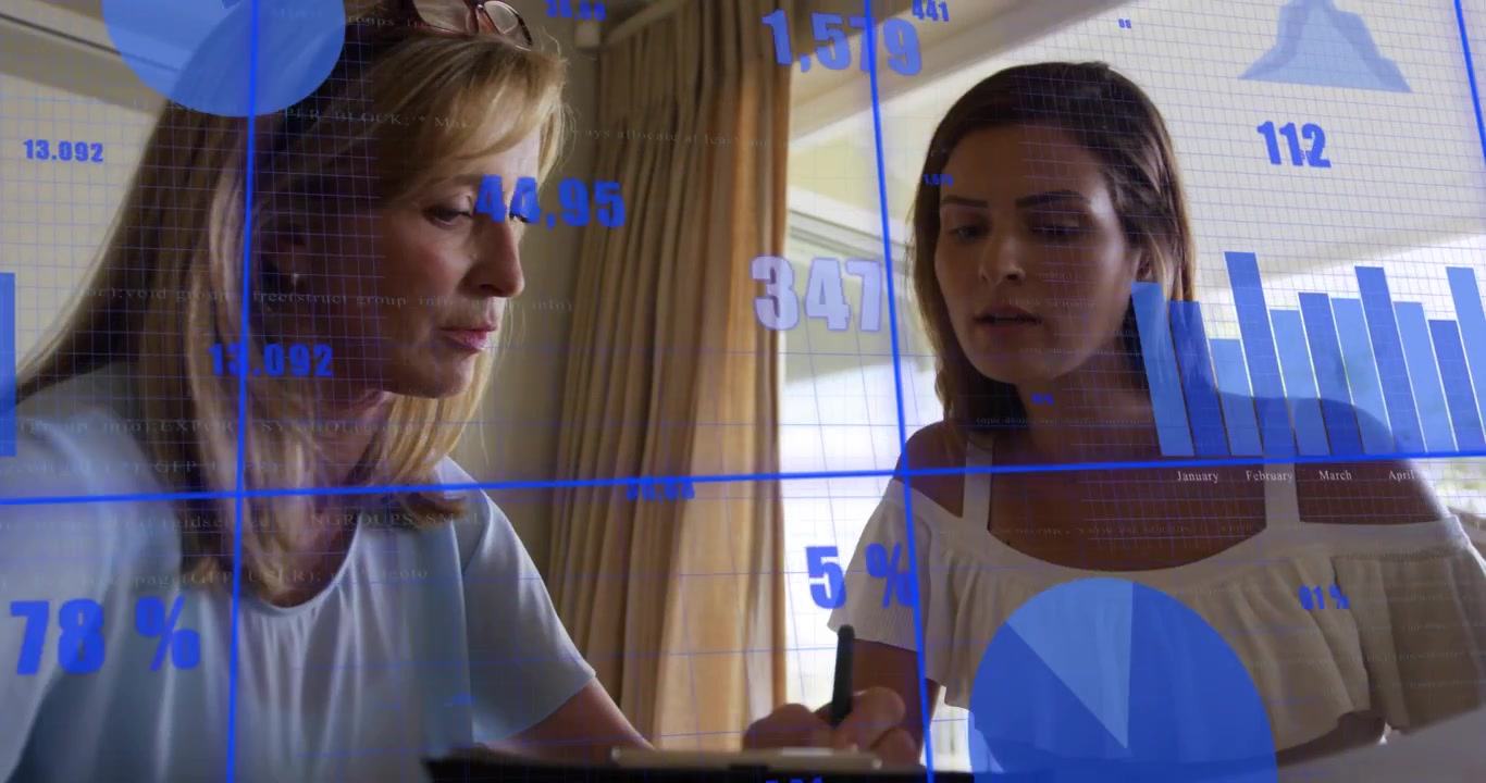 Mentor checking tablet guiding mentee noting figures while finance charts and blue percent aligning