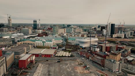 a wide drone shot pulling back from the city centre skyline in birmingham, england, uk