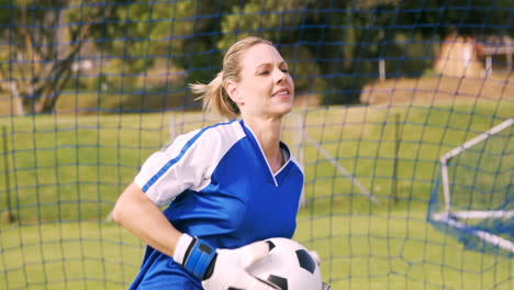 goalkeeper in blue making gesture