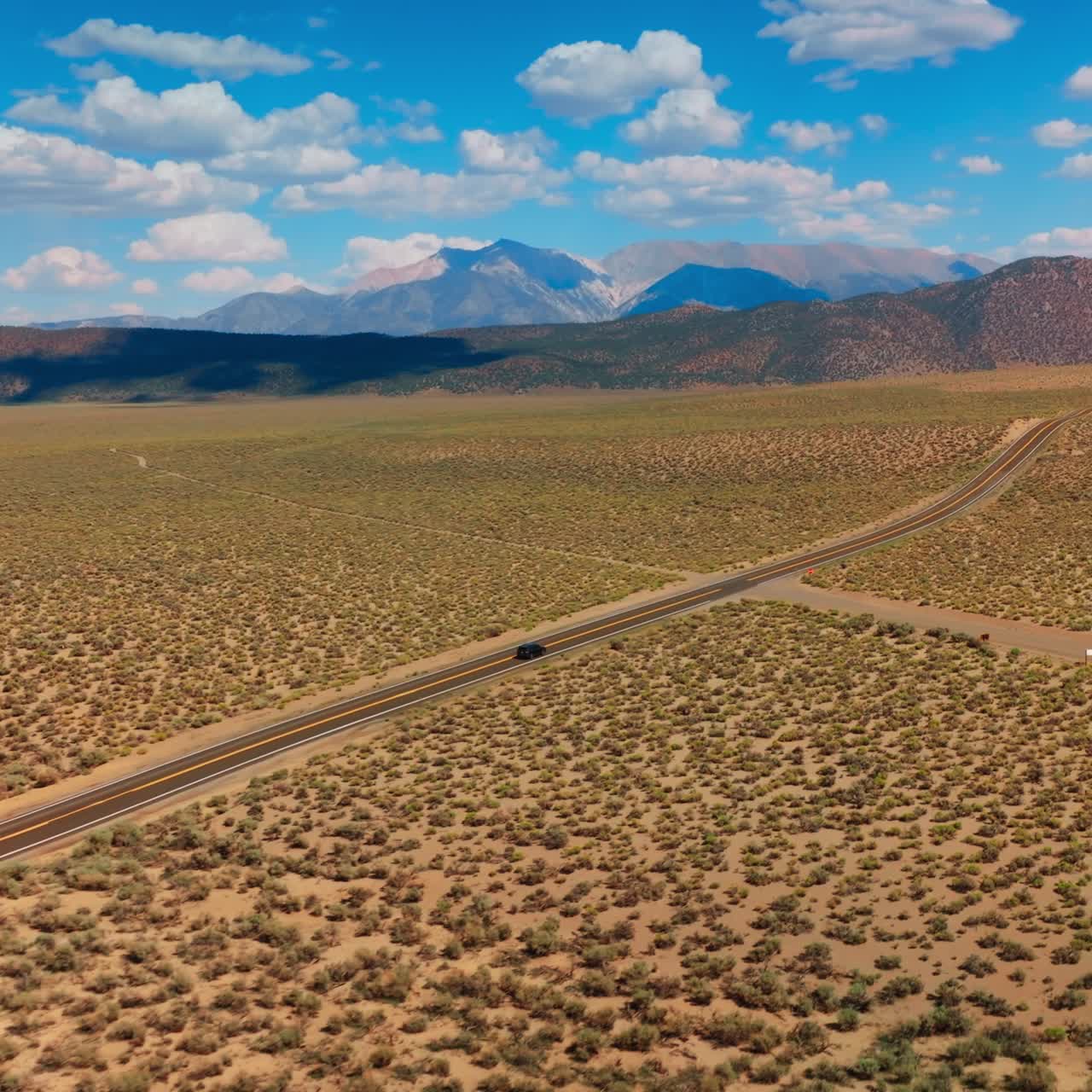 Nevada desert road aerial shot. Desert highway car driving