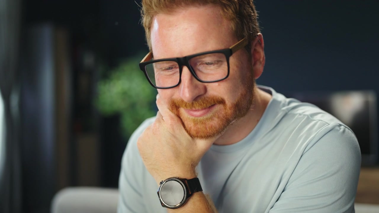 Red-Haired Man Working on Laptop at Home