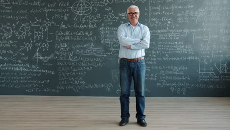 teacher in front of a chalkboard filled with equations