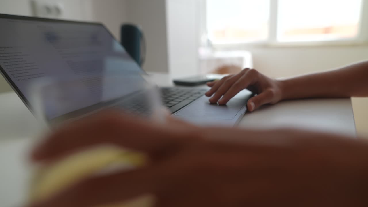 Close-up of Hand Using Laptop Trackpad While Working