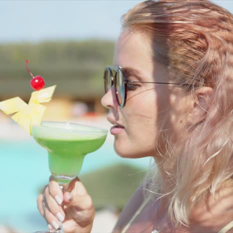 Woman-enjoying-green-cocktail-during-vacation