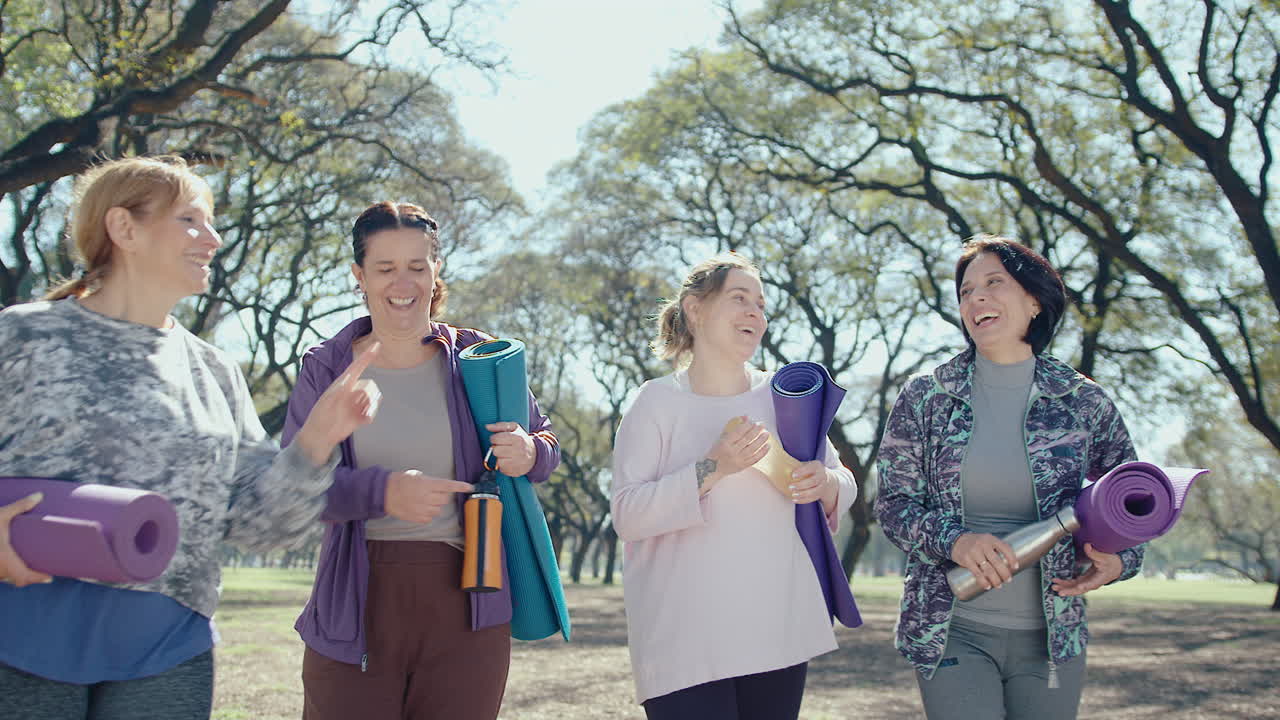 Four Women Enjoying a Yoga Walk in the Park