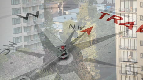 compass needle pointing north with animation of travel text over urban landscape