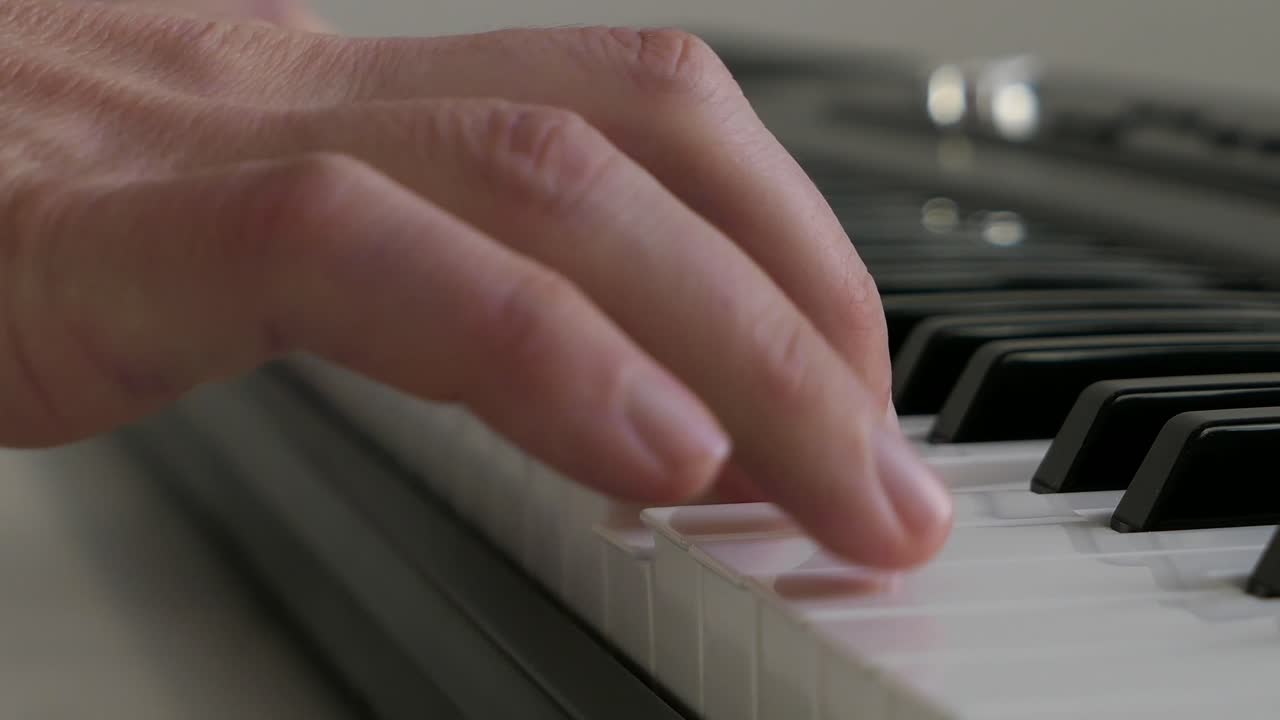 Person playing music on piano passionately and playfully, close up