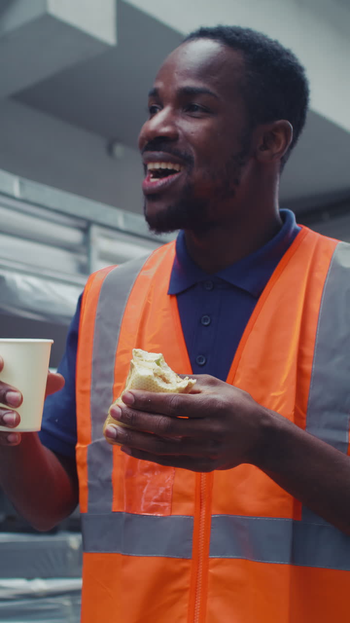 Blue collar worker in the metal processing industry having a lunch break eating his sandwich