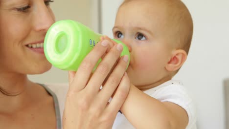 pretty young mother feeding her baby girl