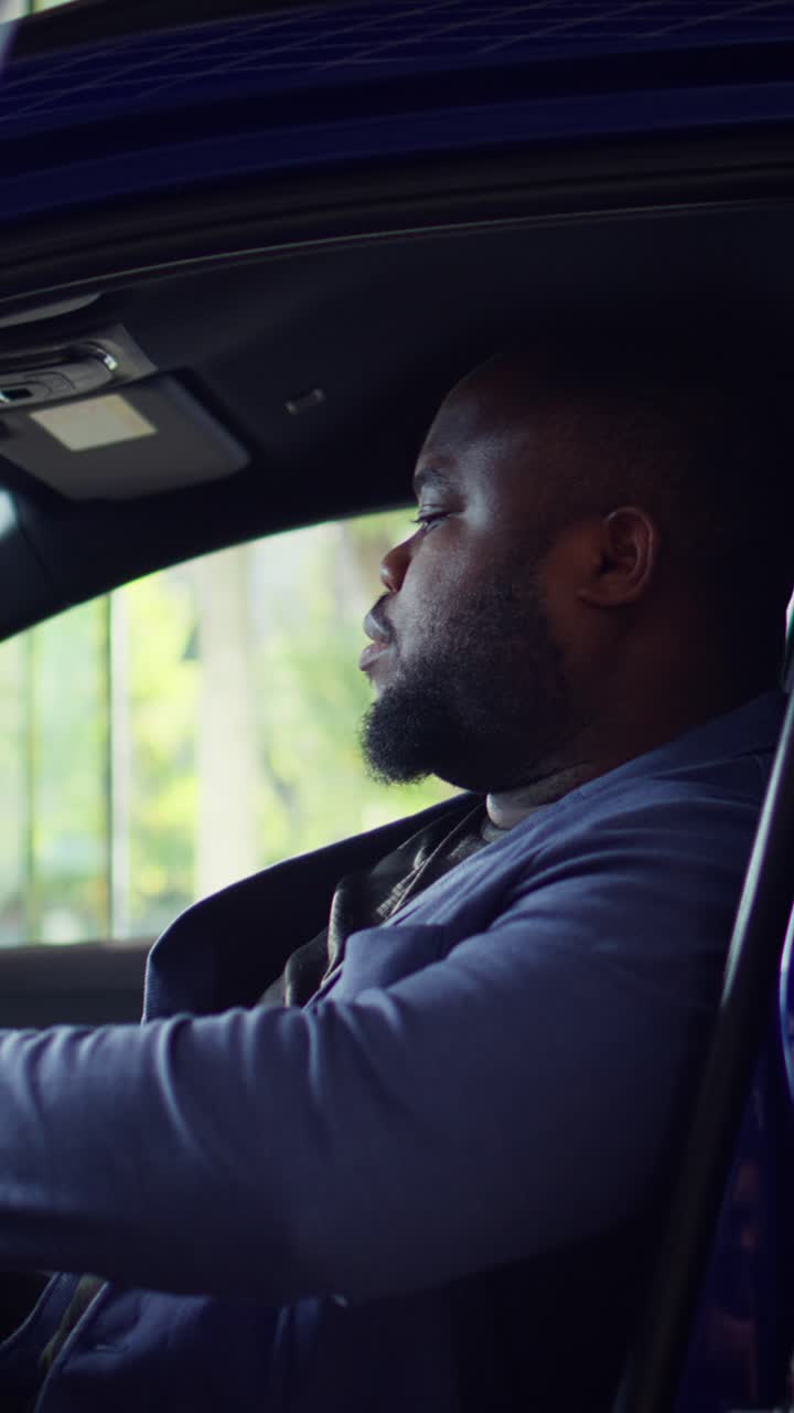 African American Man Opening Car Door and Sitting Inside