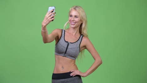 young happy beautiful woman taking selfie ready for gym