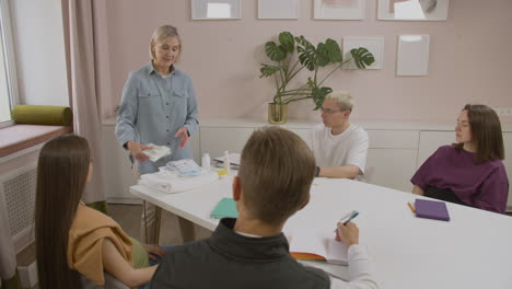 teacher showing products for the baby in class